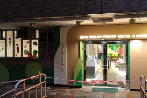 The school's entrance, lit up in the evening