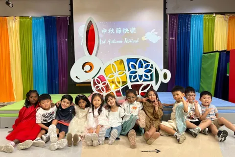 K3B 班的小朋友在中秋節慶祝活動的兔子花燈舞台佈景前合照